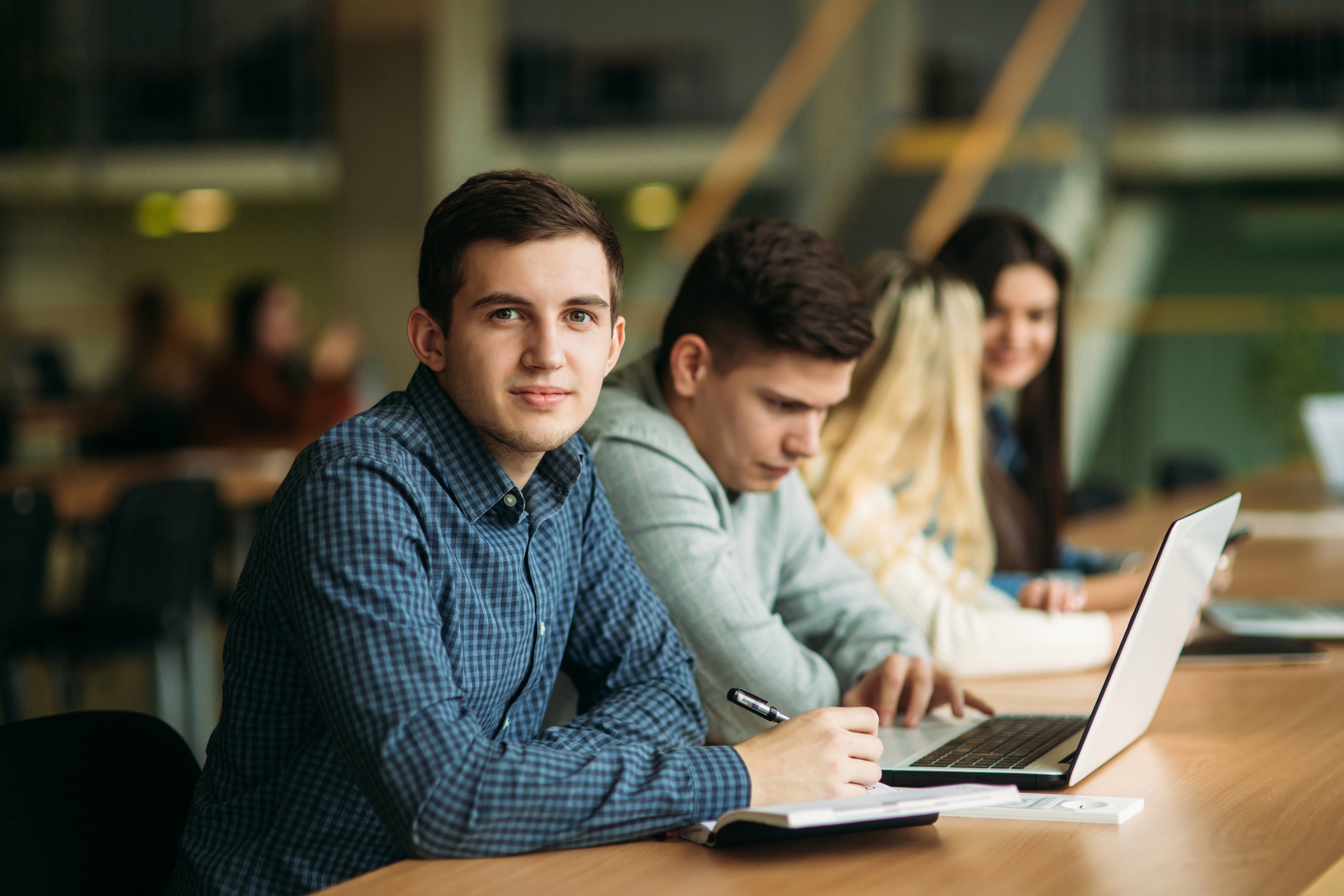 College Students with Laptop Studying in the School Library